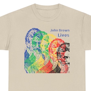 May include: A beige t-shirt with a colorful image of John Brown's face repeated four times. The text "John Brown Lives" is printed in black above the image.