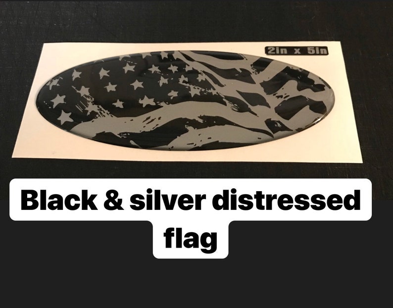 May include: A black and silver distressed American flag decal, 2 inches by 5 inches.