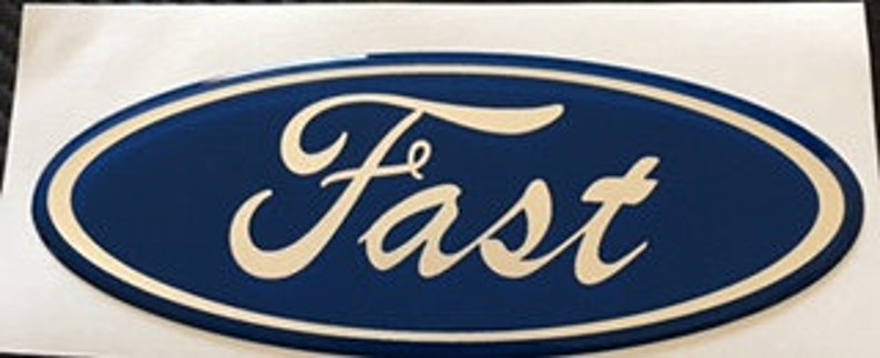 May include: A blue oval-shaped emblem with a white outline and the word "Fast" written in a stylized white script font.