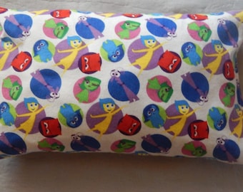 May include: A white pillow with a colorful pattern of cartoon characters from the movie Inside Out. The characters are in circles on a white background. The characters are Joy, Sadness, Anger, Fear, and Disgust.