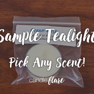 May include: A white sample tea light candle in a clear plastic bag with the text "Sample Tealight Pick Any Scent! candle flare" on the label.