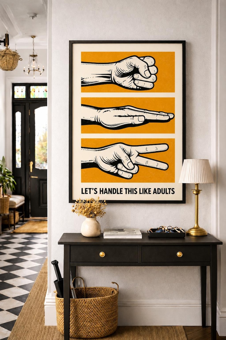 May include: A rectangular wall art print in a black frame featuring three horizontal orange panels with black and white illustrations of a fist, a flat hand, and a peace sign. The text "LET'S HANDLE THIS LIKE ADULTS" is printed in black below.
