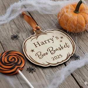 Personalized Baby&#39;s First Halloween Wooden Pumpkin Ornament - Custom Boo Basket Tag beautifully and simple.
