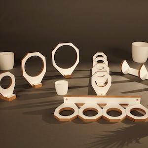 May include: White wooden wall mounted plant hangers in various shapes and sizes. The hangers are designed to hold small potted plants.