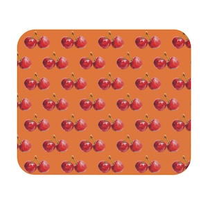 May include: A square-cornered mousepad featuring a repeating pattern of watercolor cherries on an orange background. Each cherry cluster has two or three red cherries with green stems.