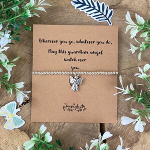 May include: A silver charm bracelet with an angel charm. The bracelet is on a card with the text "Wherever you go, whatever you do, May this guardian angel watch over you".