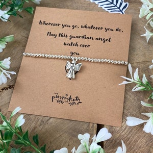 May include: A silver charm bracelet with an angel charm. The bracelet comes with a card that reads "Wherever you go, whatever you do, May this guardian angel watch over you." The card is signed "The Persnickety Co."