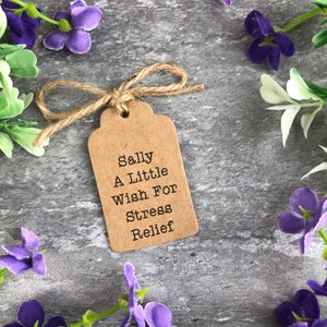 May include: A brown paper gift tag with twine tied around it. The tag has the text "Sally A Little Wish For Stress Relief" printed on it.