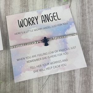 May include: A silver beaded bracelet with a black angel charm and a card that reads "Worry Angel. Here's a little worry angel just for you. When you are feeling low or anxious just remember she is here for you. Tell her your worries and she will help calm you."