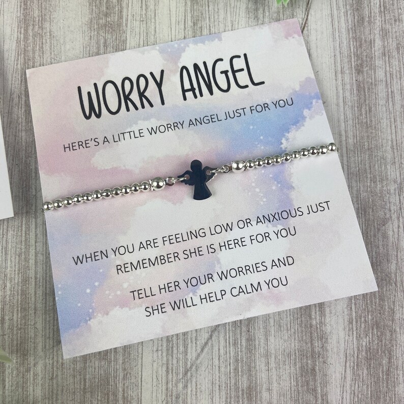 May include: A silver beaded bracelet with a black angel charm and a card that reads "Worry Angel. Here's a little worry angel just for you. When you are feeling low or anxious just remember she is here for you. Tell her your worries and she will help calm you."