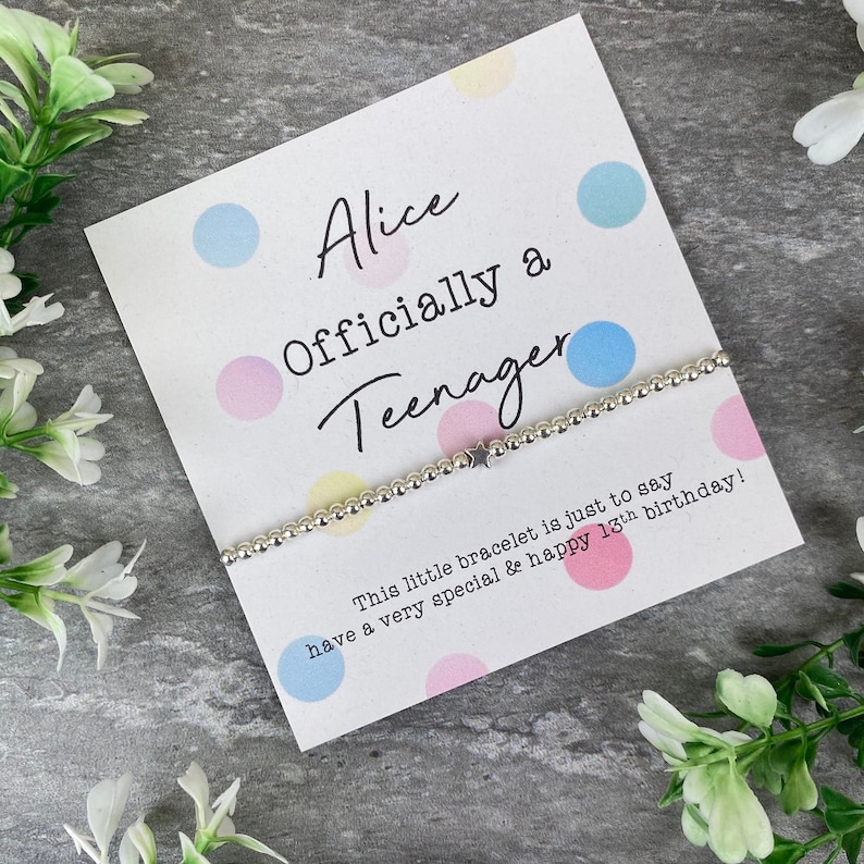 May include: A white card with colorful polka dots reads "Alice Officially a Teenager". A silver bracelet with a star charm is on the card. The text on the card reads "This little bracelet is just to say have a very special & happy 13th birthday!"