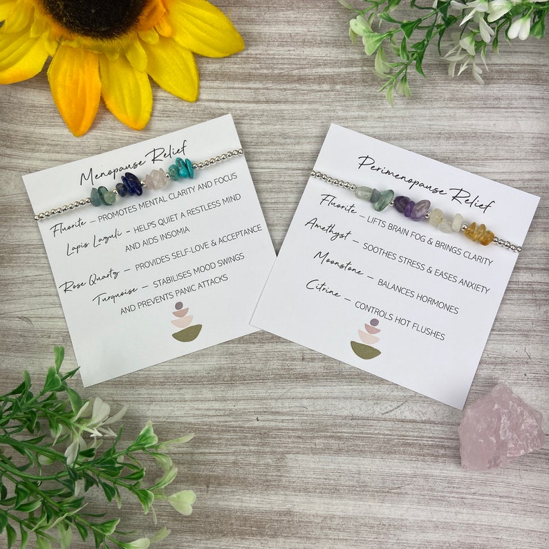 May include: Two white cards with black text describing the benefits of crystals for menopause and perimenopause relief. Each card features a silver bracelet with different colored stones, including fluorite, amethyst, moonstone, rose quartz, lapis lazuli, turquoise, and citrine.