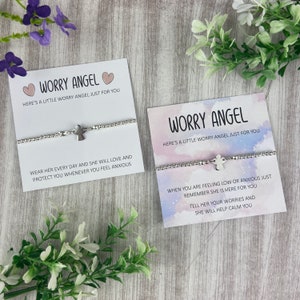 May include: Two silver bracelets with angel charms and cards that read "Worry Angel" and include messages about wearing the bracelet to feel calm and protected.