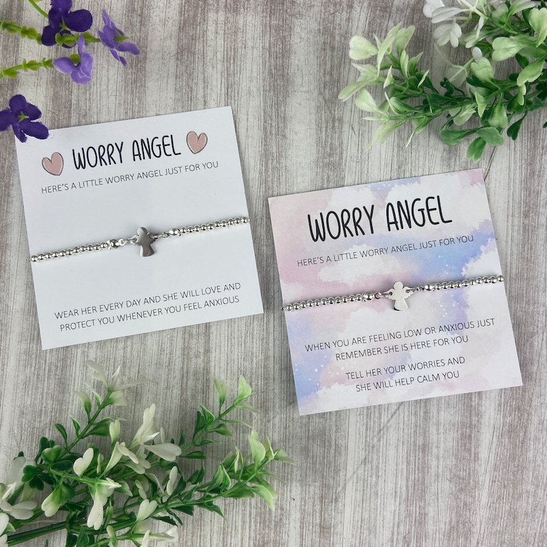 May include: Two silver bracelets with angel charms and cards that read "Worry Angel" and include messages about wearing the bracelet to feel calm and protected.
