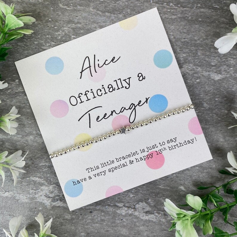 May include: A silver bracelet with a star charm on a card with colorful polka dots and the text "Alice Officially a Teenager This little bracelet is just to say have a very special & happy 13th birthday!"