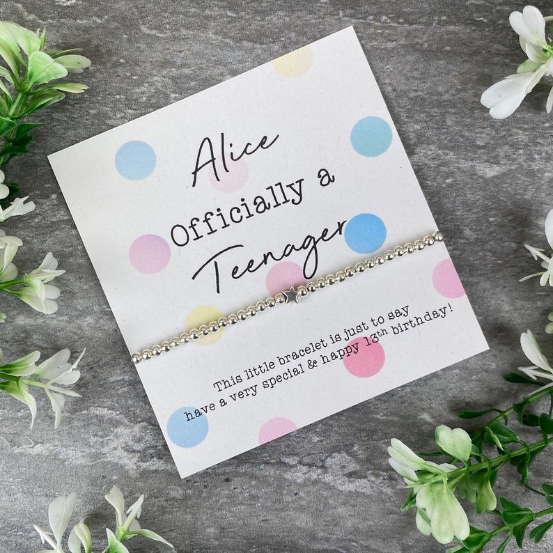 May include: A white card with colorful polka dots reads "Alice Officially a Teenager". A silver bracelet with a star charm is on the card. The text below the card reads "This little bracelet is just to say have a very special & happy 13th birthday!"