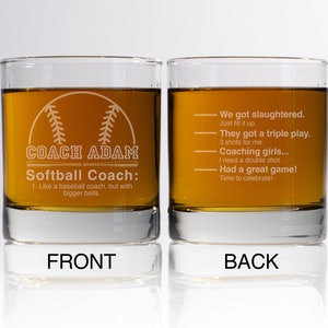 May include: Two clear glass tumblers with a white design. The front tumbler has a baseball graphic and the text "COACH ADAM Softball Coach: 1. Like a baseball coach, but with bigger balls." The back tumbler has the text "We got slaughtered. Just fill it up. They got a triple play. 3 shots for me. Coaching girls... I need a double shot. Had a great game! Time to celebrate!"