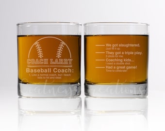 May include: Two clear glass whiskey tumblers with a baseball theme. The tumbler on the left has a baseball graphic and the text "COACH LARRY Baseball Coach: 1. Like a normal coach, but I teach kids to hit and steal." The tumbler on the right has the text "We got slaughtered. Just fill it up. They got a triple play. 3 shots for me. Coaching kids... I need a double shot. Had a great game! Time to celebrate!"