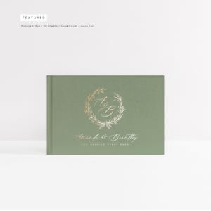 May include: Sage green wedding guest book with gold foil lettering. The cover features a wreath with the letters "A & B" and the text "Aranh & Brentley Wedding Guest Book".