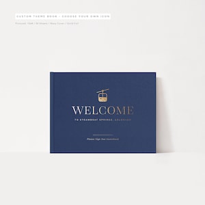 May include: A navy blue guest book with gold foil lettering that reads "Welcome to Steamboat Springs, Colorado". The cover features a gold foil icon of a gondola.