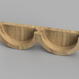 May include: A wooden, two-piece, half-circle shaped mold for making soap or candles.