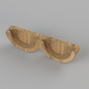 May include: A wooden double cup holder with a natural wood finish. The holder is designed to hold two cups or mugs.