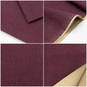 May include: Close-up of a deep purple fabric with a textured weave. The fabric is folded over to show the underside, which is a light beige colour.