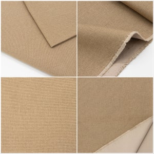 May include: Close-up of a beige canvas fabric with a subtle texture. The fabric is folded in half, showing the raw edge of the material.