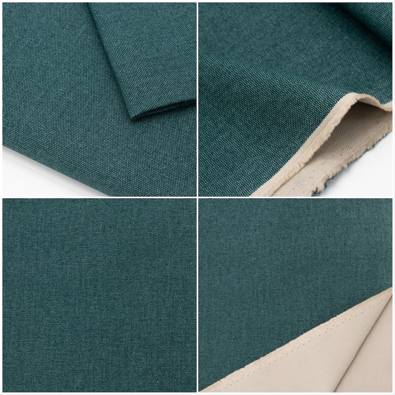 May include: Close-up of a dark teal fabric with a subtle textured weave. The fabric is folded in several places, showing the raw edge and the underside of the fabric, which is a light beige colour.
