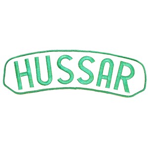 May include: A white patch with green embroidered lettering that reads "HUSSAR".