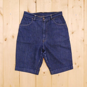 May include: A pair of dark blue denim shorts with a high waist and cuffed hems.
