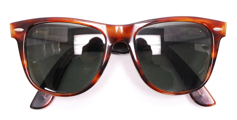 Puede incluir: Gafas de sol de carey con lentes verde oscuro. Las gafas tienen un estilo aviador cl&aacute;sico.