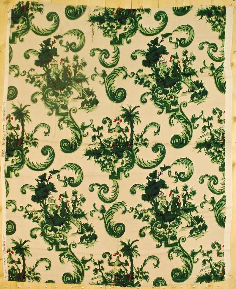 May include: A cream-colored fabric with a repeating pattern of green stylized foliage, trees, and pagodas. The pattern is reminiscent of a chinoiserie design.