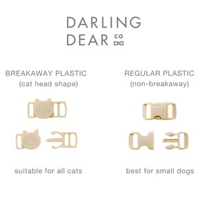 May include: Beige plastic breakaway and regular buckles for pet collars. The breakaway buckle is cat-shaped and suitable for all cats. The regular buckle is best for small dogs. The text "DARLING DEAR CO" is at the top.