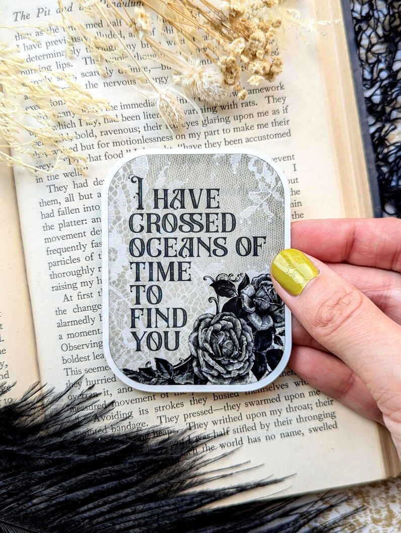 May include: A black and white sticker with a floral design and the text "I have crossed oceans of time to find you".