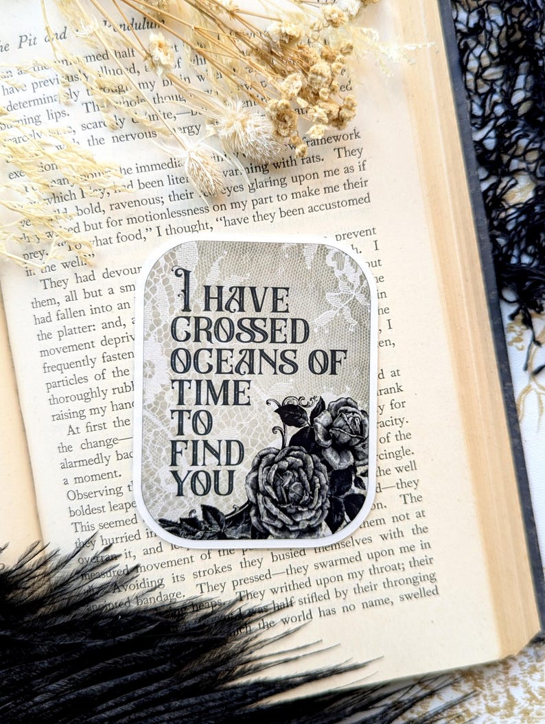 May include: A black and white sticker with a floral design and the text "I have crossed oceans of time to find you".