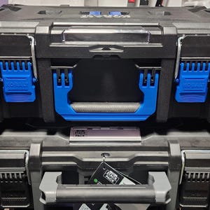 May include: Two black and blue stackable toolboxes. The top toolbox has blue latches and a blue handle. The bottom toolbox has gray latches and a gray handle. The brand name "KOBALT" is visible on the top toolbox.