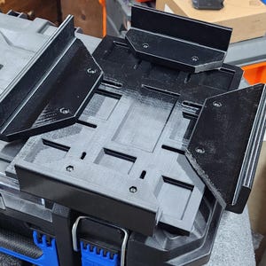 May include: Black plastic tool organizer with multiple compartments, designed to fit on top of a toolbox. The organizer has a textured surface and is made of durable plastic.