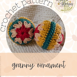 May include: Two crocheted Christmas baubles in a granny square pattern. One bauble is red, pink, and green, and the other is yellow, green, and brown. The baubles are on a white fluffy surface. The text "crochet pattern" is written in black on a white background. The text "bobbles & blooms crochet co." is written in black on a white background inside a circle with a floral design. The text "modern heirloom handmade" is written in black on a white background.