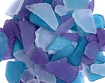 May include: A collection of sea glass in shades of purple and blue. The glass pieces are various shapes and sizes.