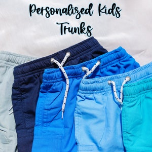 May include: Four pairs of swim trunks in different shades of blue, teal, and gray. The trunks are made of a soft, comfortable fabric and have an elastic waistband with a drawstring.