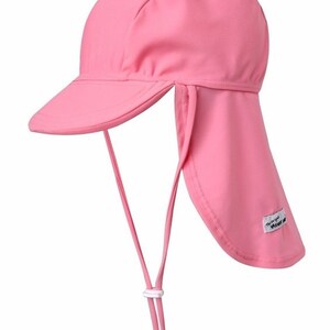 May include: Pink sun hat with a long flap that can be tied at the back of the neck. The hat has a small brim and a white label that says "The Original  VENT  ME"