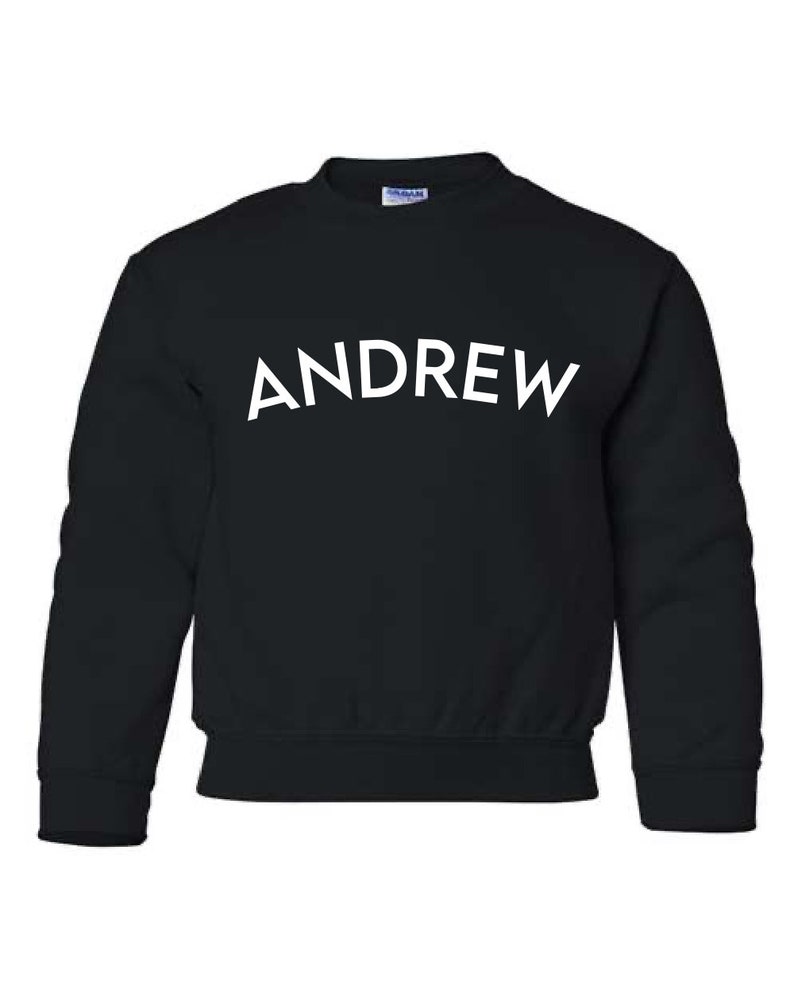 May include: Black sweatshirt with the word "ANDREW" printed in white on the front.