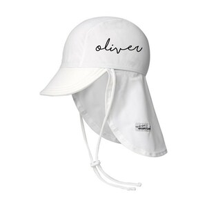 May include: White sun hat with a long flap that can be tied at the back of the neck. The hat has a brim and the word "oliver" is written on the front in black.