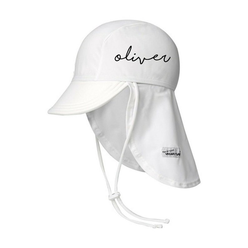 May include: White sun hat with a long flap that can be tied at the back of the neck. The hat has a brim and the word "oliver" is written on the front in black.