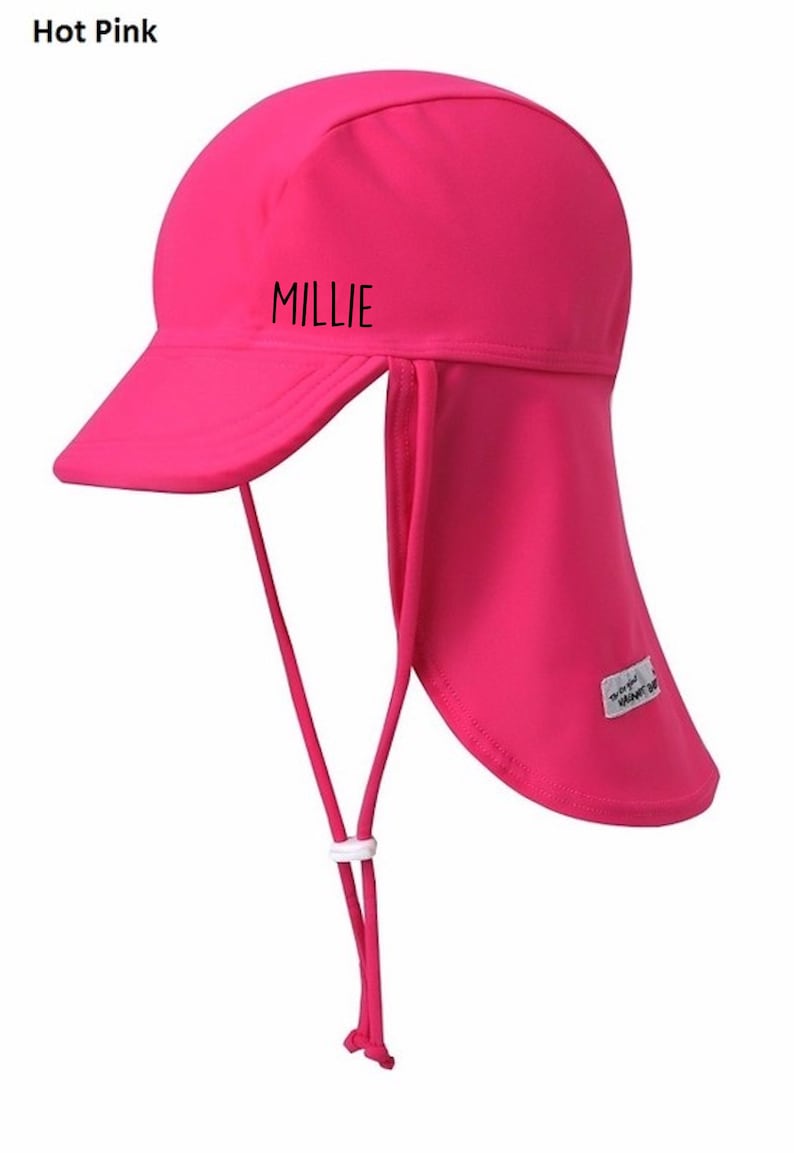 May include: Hot pink sun hat with a long flap in the back to protect the neck. The hat has a brim and a chin strap. The hat says "MILLIE" on the front.