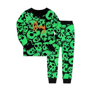 May include: Black and green pajamas with a skull print. The top has the name "Rory" written in orange on the front.