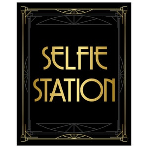 May include: A black and gold art deco style sign with the text "SELFIE STATION" in gold lettering.