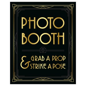 May include: Black rectangular sign with gold text that reads "PHOTO BOOTH & GRAB A PROP & STRIKE A POSE." The sign has a gold art deco border and a camera icon.