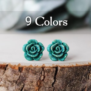 May include: A pair of teal blue glitter rose stud earrings. 9 Colors.